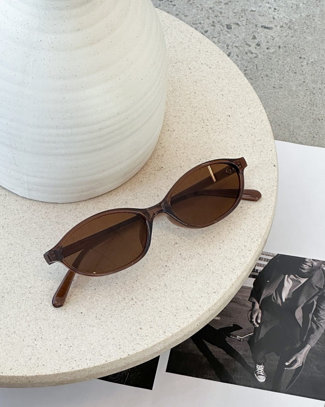 Black women's oval sunglasses, classic retro 90s style eyewear; lightweight fashion accessory.