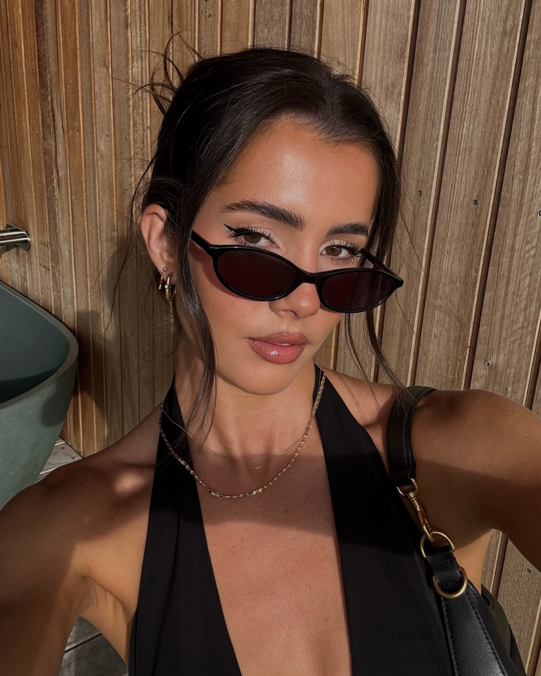 Women's sleek oval sunglasses with retro 90s fashion vibe. A stylish & minimalist accessory.