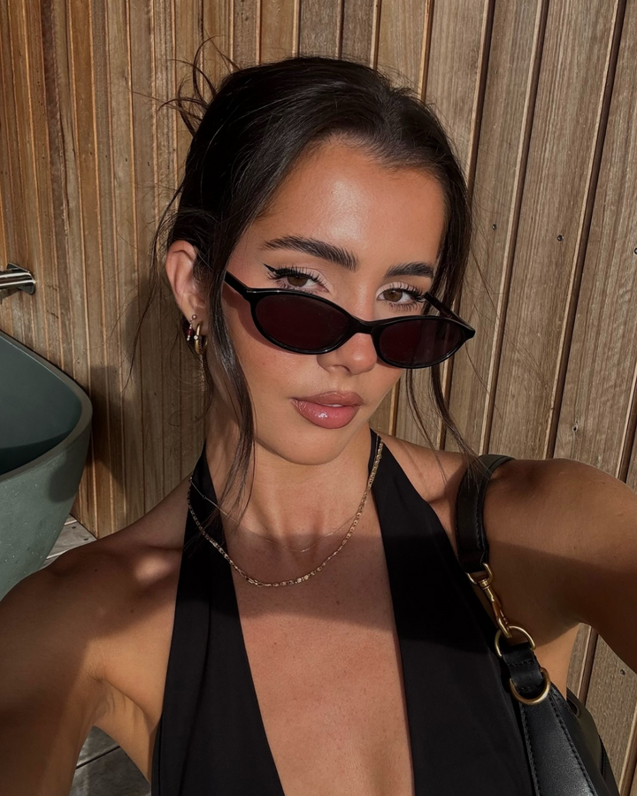 Women's sleek oval sunglasses with retro 90s fashion vibe. A stylish & minimalist accessory.