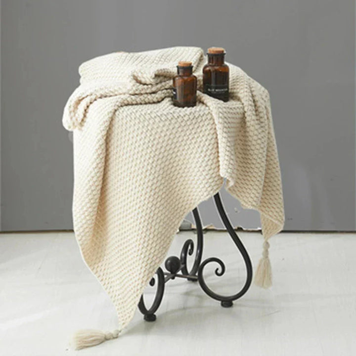 Soft NordicCozy knitted wool blanket, a warm and plush throw with tassels for elegant home bedroom decor.