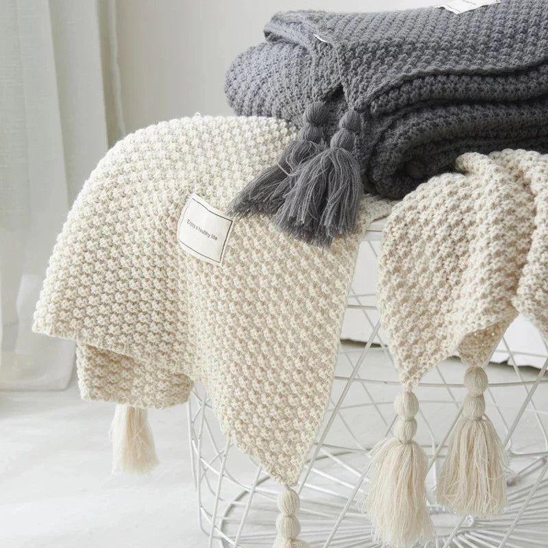 Versatile knitted wool blanket, a cozy tassel throw for your living room or bedroom, providing ultimate comfort.