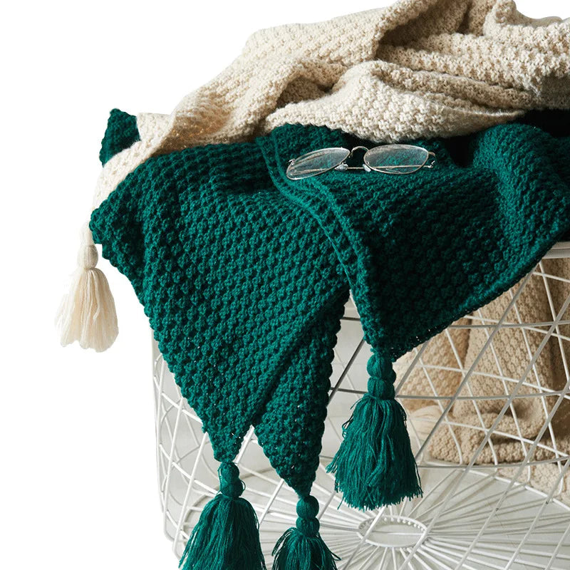 Luxurious NordicCozy knitted wool throw, a warm and cozy blanket with stylish tassels for modern home decor.