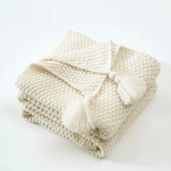 Decorative knitted wool blanket, a stylish tassel throw bringing ultimate comfort and warmth to your living space.