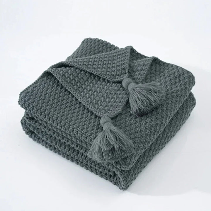 Premium NordicCozy knitted wool blanket, a cozy and warm throw with elegant tassels for ultimate comfort.