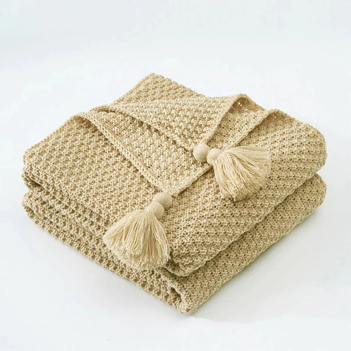 Plush knitted wool throw, a comfortable blanket with intricate tassels, perfect for your bedroom or living room.
