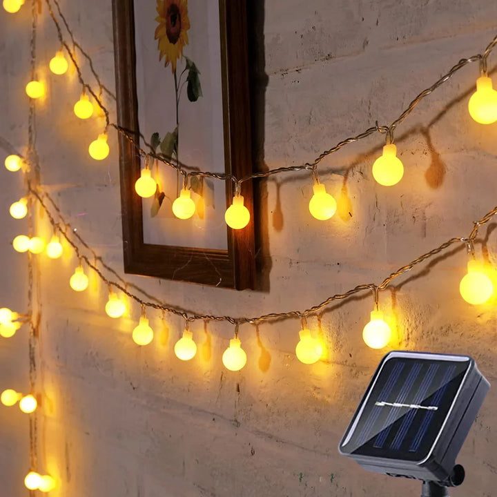 Eco-friendly solar-powered LED festoon string lights for outdoor garden & patio party lighting.