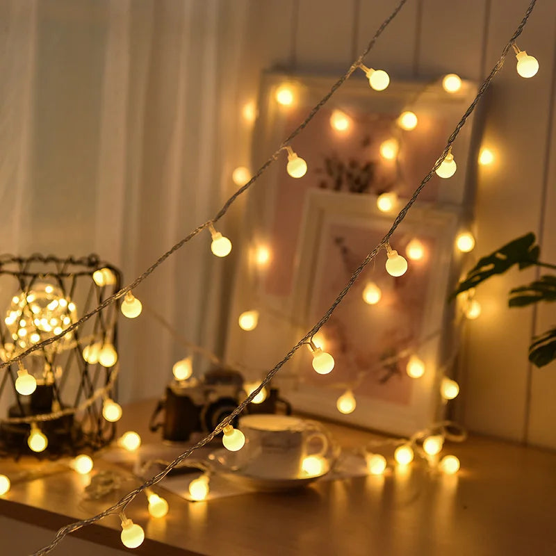 Party-ready solar LED festoon string lights enhancing outdoor garden & patio celebrations.
