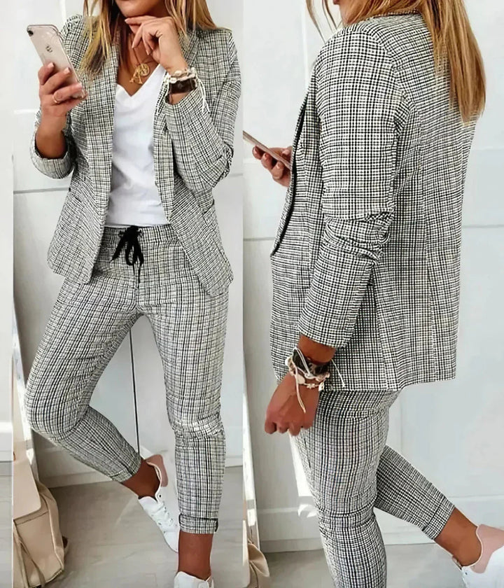 Women's formal two-piece business suit, featuring a stylish jacket and trousers for sophisticated office attire.