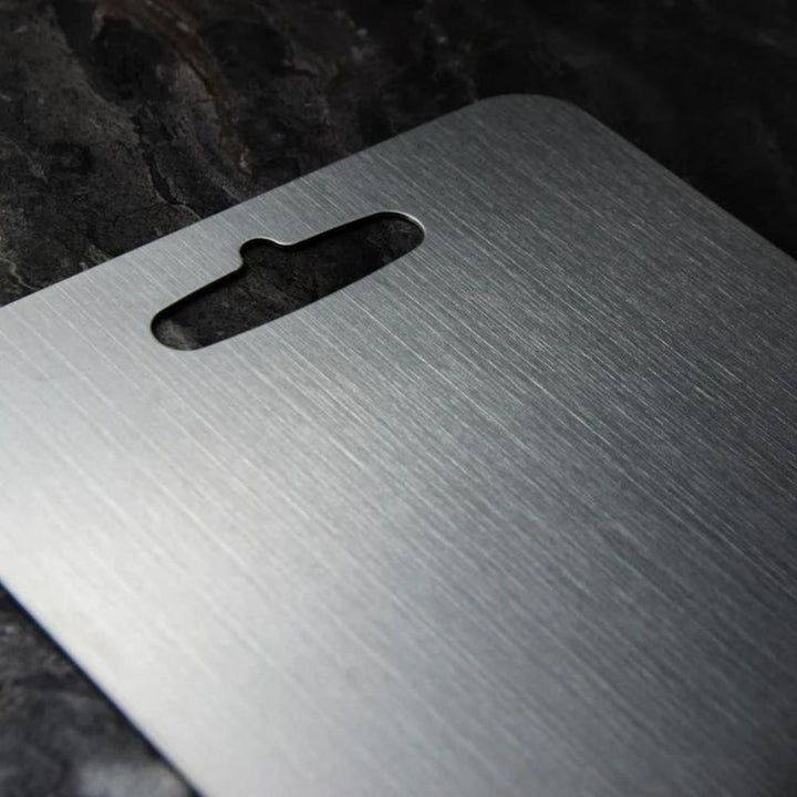 "Stainless steel cutting board, non-slip, scratch-resistant surface for hygienic food prep, sleek design for kitchen use."