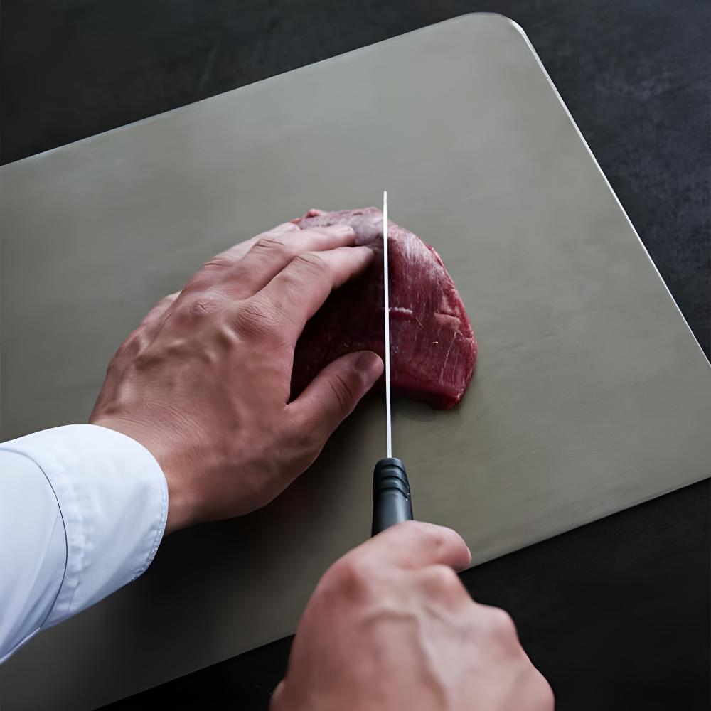 "Stainless steel cutting board, non-slip, scratch-resistant surface for hygienic food prep, sleek design for kitchen use."