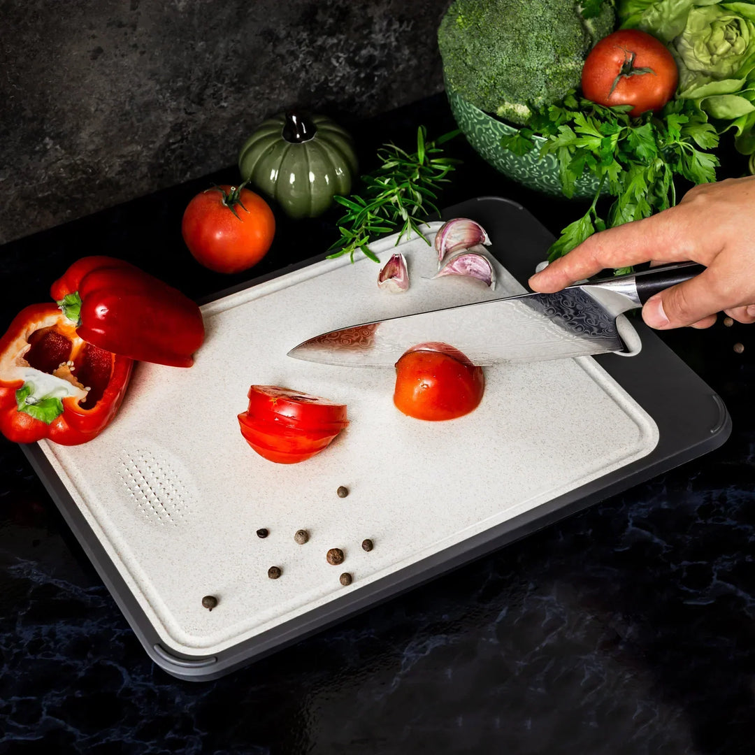 Stainless steel cutting board with a smooth finish and non-slip ergonomic handle, ideal for precise and hygienic kitchen prep