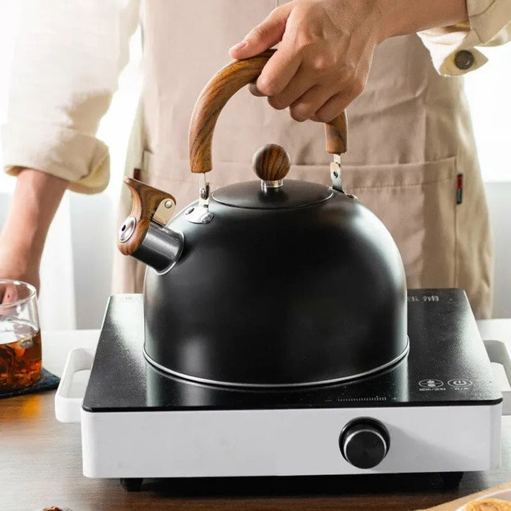 "Stainless steel whistling kettle with insulated handle, sleek design; kitchen essential for all stovetops, 3L capacity."
