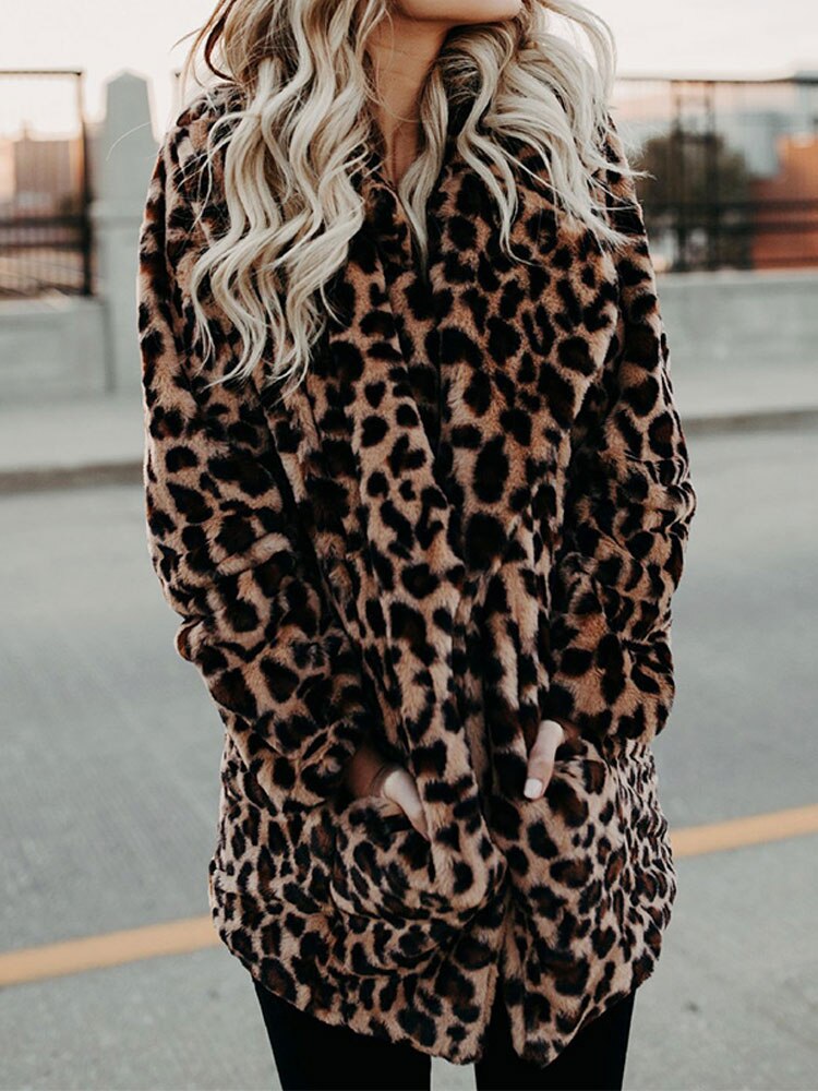 Chic women's leopard print winter coat, Sofia style. Warm, fashionable outerwear for a bold winter look.