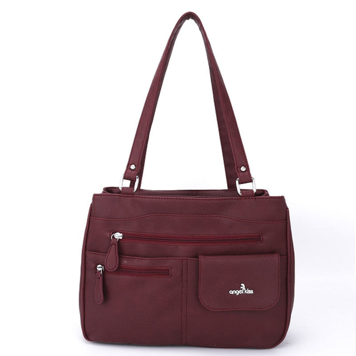 Fashionable woman carrying the FlexiCarry multi-compartment shoulder bag, a versatile PU leather women's handbag.