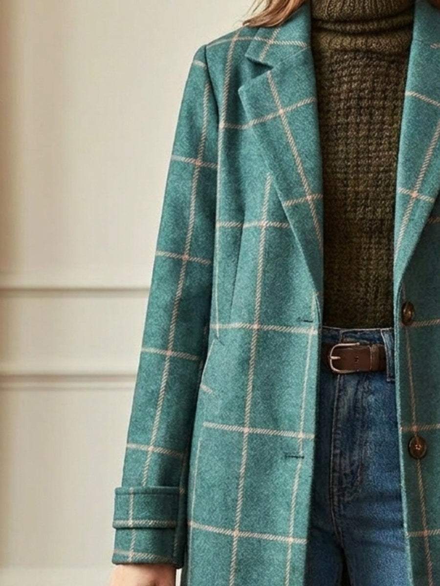 Fashionable women's green checkered long trench coat featuring classic lapels. A stylish choice for outerwear.