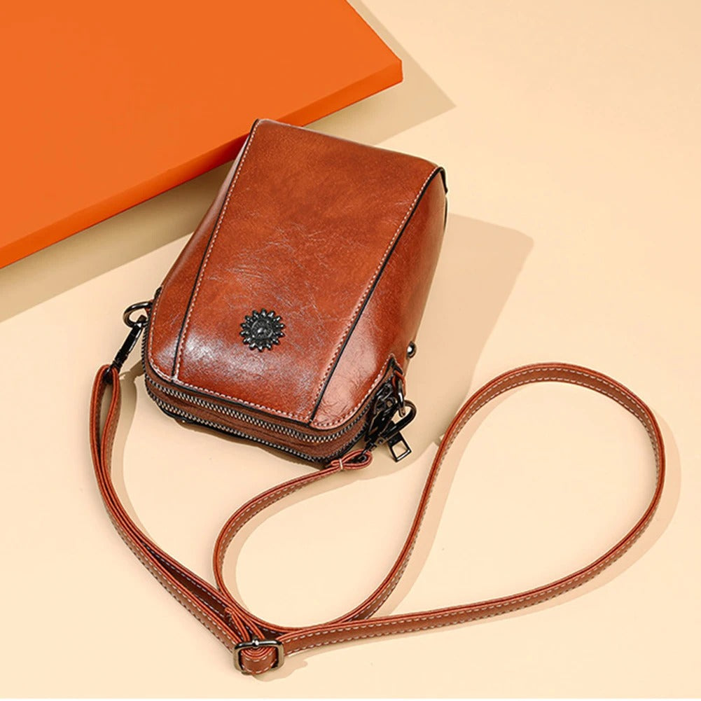 Classic black leather women's handbag, a stylish & versatile shoulder bag with an adjustable strap.