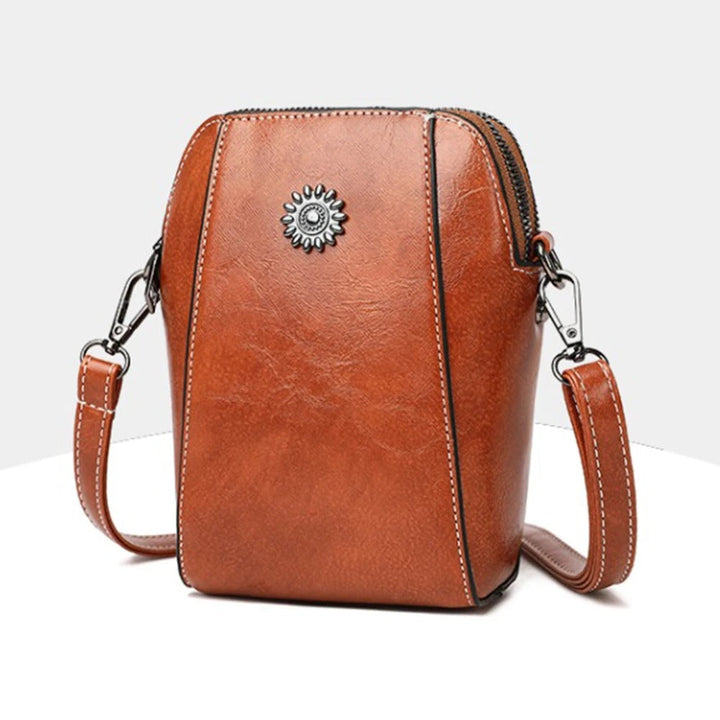 Vibrant red leather women's handbag, stylish & versatile shoulder bag with adjustable strap.