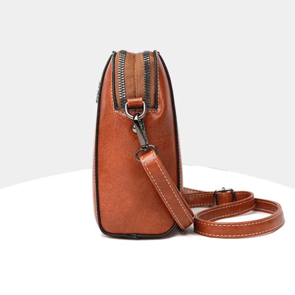 Durable women's leather shoulder bag, versatile daily use handbag with an adjustable strap, elegant style.