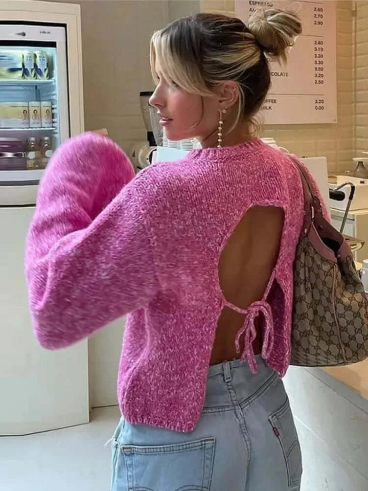 Modern women's cropped long sleeve top with an elegant open back, ideal for trendy casual outfits.