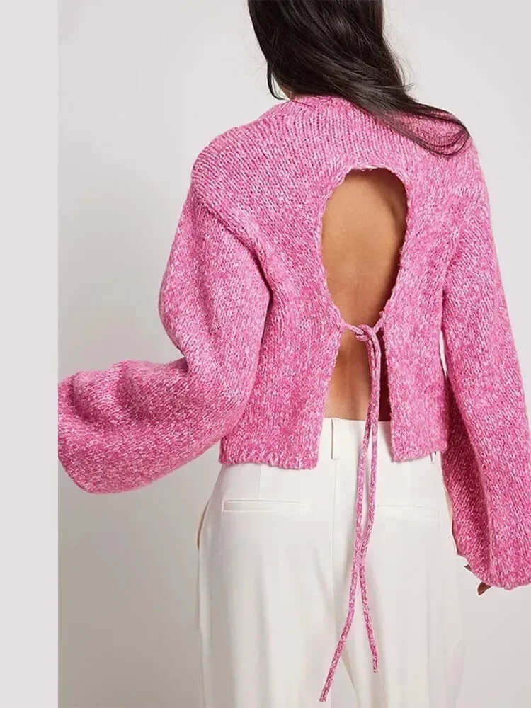 Fashionable women's fitted long sleeve crop top, showcasing a chic open back detail for a stylish silhouette.