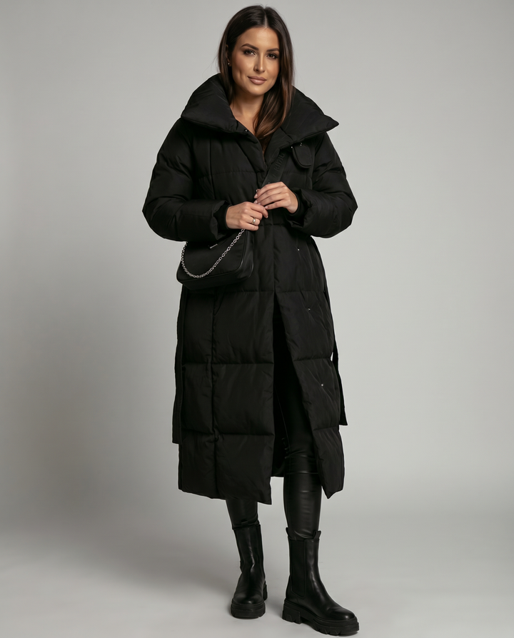 Warm women's long winter coat. A cozy puffer jacket designed for comfort and style in cold weather.