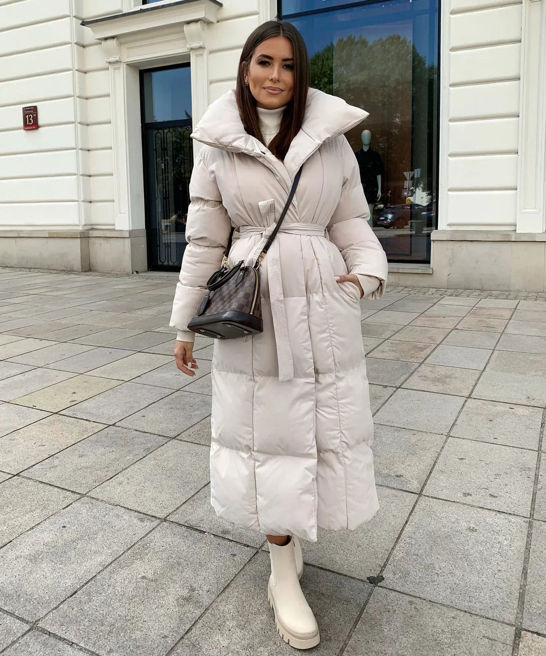 Trendy women's long winter coat. A comfortable and cozy puffer jacket, perfect for stylish cold weather outfits.
