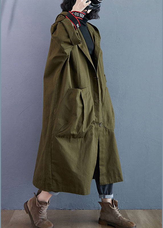 Close-up of a women's oversized trench coat, highlighting the classic button front closure & practical hood. Everyday style.