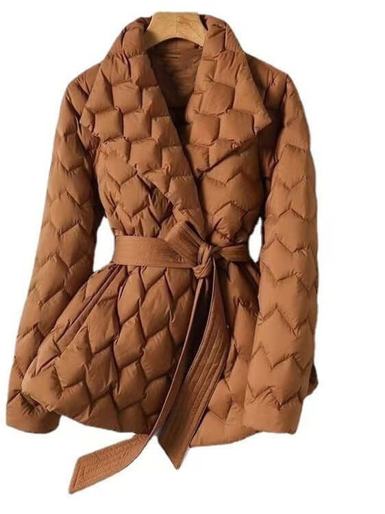 Stylish women's quilted winter jacket in caramel with a chic tie belt, perfect for warm, elegant cold weather fashion.