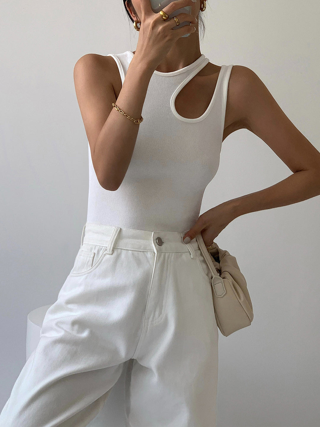 Women's sleek ribbed tank top featuring a unique asymmetrical shoulder cutout, modern and stylish.