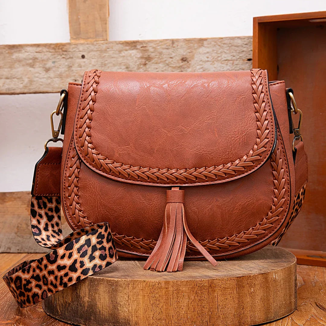 Stylish women's small shoulder bag, faux leather with chic tassel detail, perfect everyday fashion accessory.
