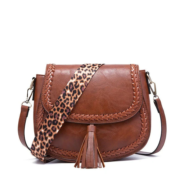 Elegant women's small black tassel bag, faux leather cross-body style, a sophisticated and everyday accessory.