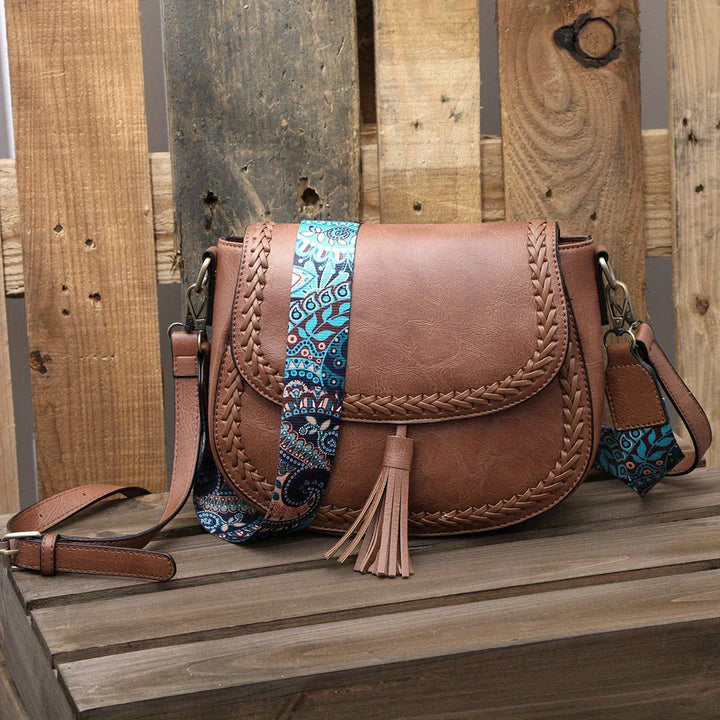 Brown faux leather women's cross-body bag with stylish tassel, versatile and chic everyday handbag.