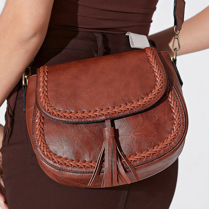 White stylish small faux leather shoulder bag for women, with fashionable tassel, ideal for everyday use.