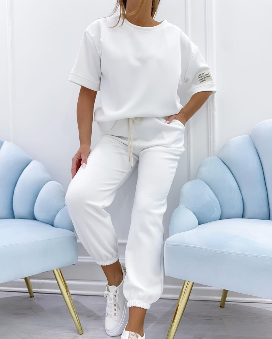 Stylish women's two-piece set featuring a short sleeve top and matching casual pants, perfect for summer.