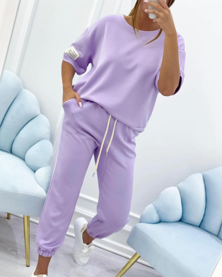 Chic women's short sleeve top and pant set, ideal for stylish casual outings or comfortable summer loungewear.