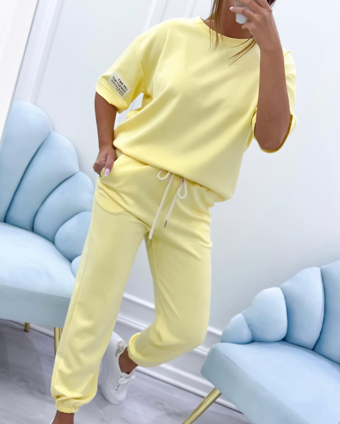 Breathable women's two-piece set featuring a short sleeve top and matching casual pants for summer style.