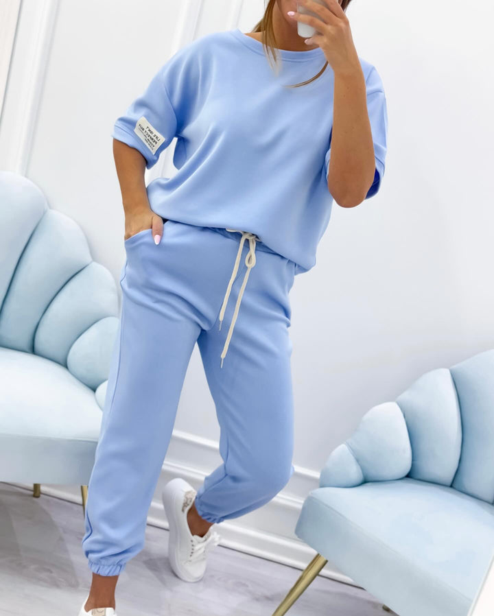 Lightweight women's short sleeve top and pant set, designed for stylish and comfortable summer wear.