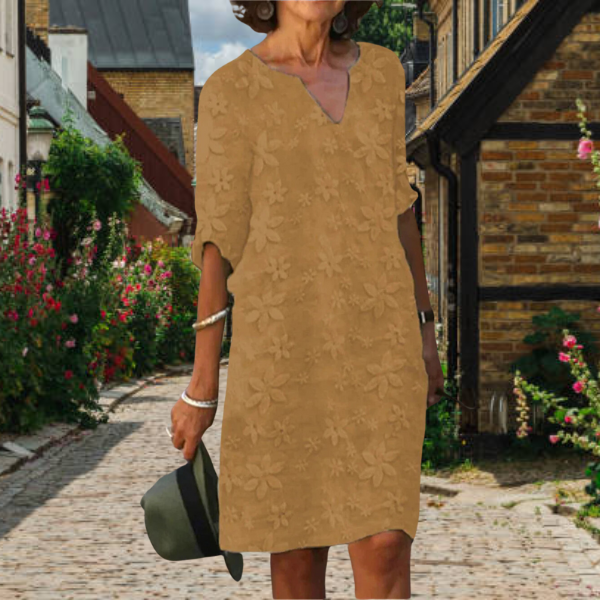 Chic women's summer dress featuring a vibrant floral print, v-neck, and half sleeves. Great for everyday wear.