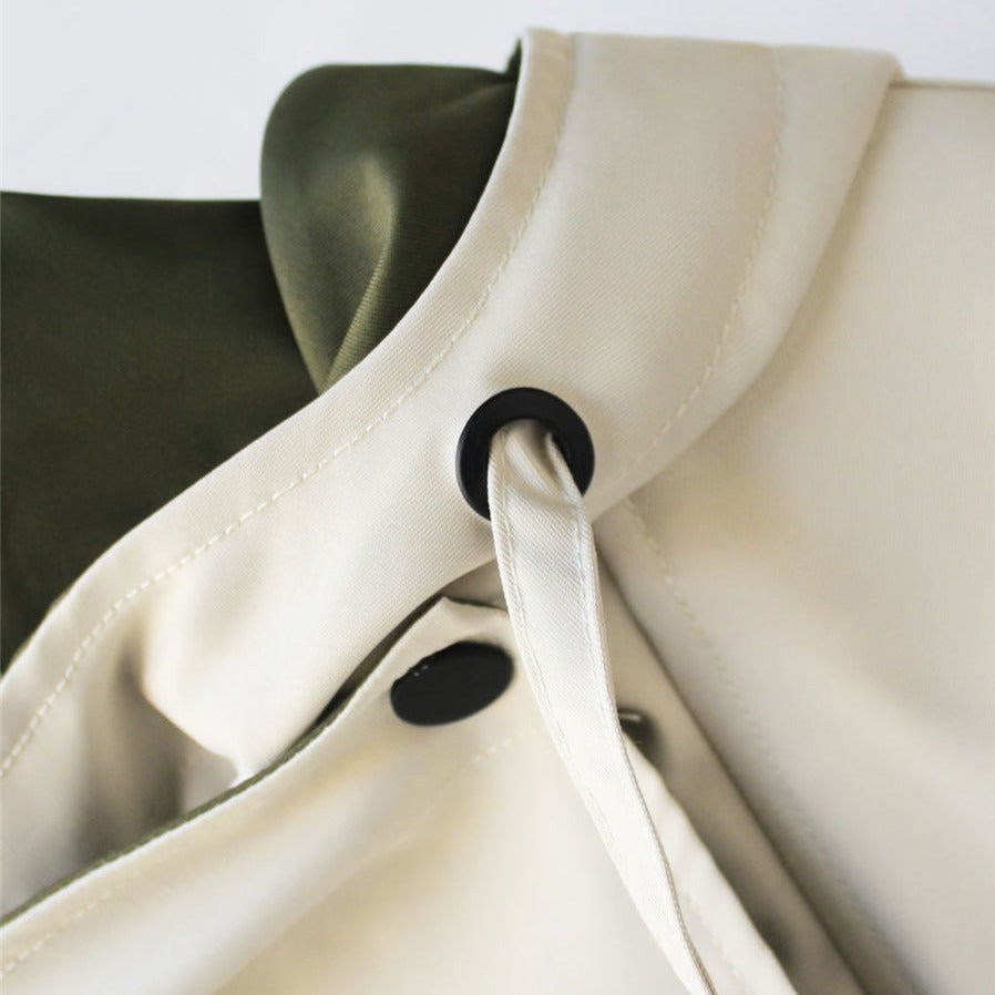 Woman wearing a chic waterproof rain jacket outdoors. Perfect lightweight outerwear for all-season weather protection.