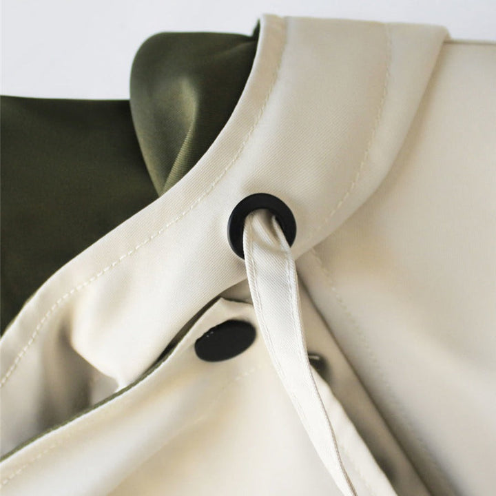 Woman wearing a chic waterproof rain jacket outdoors. Perfect lightweight outerwear for all-season weather protection.