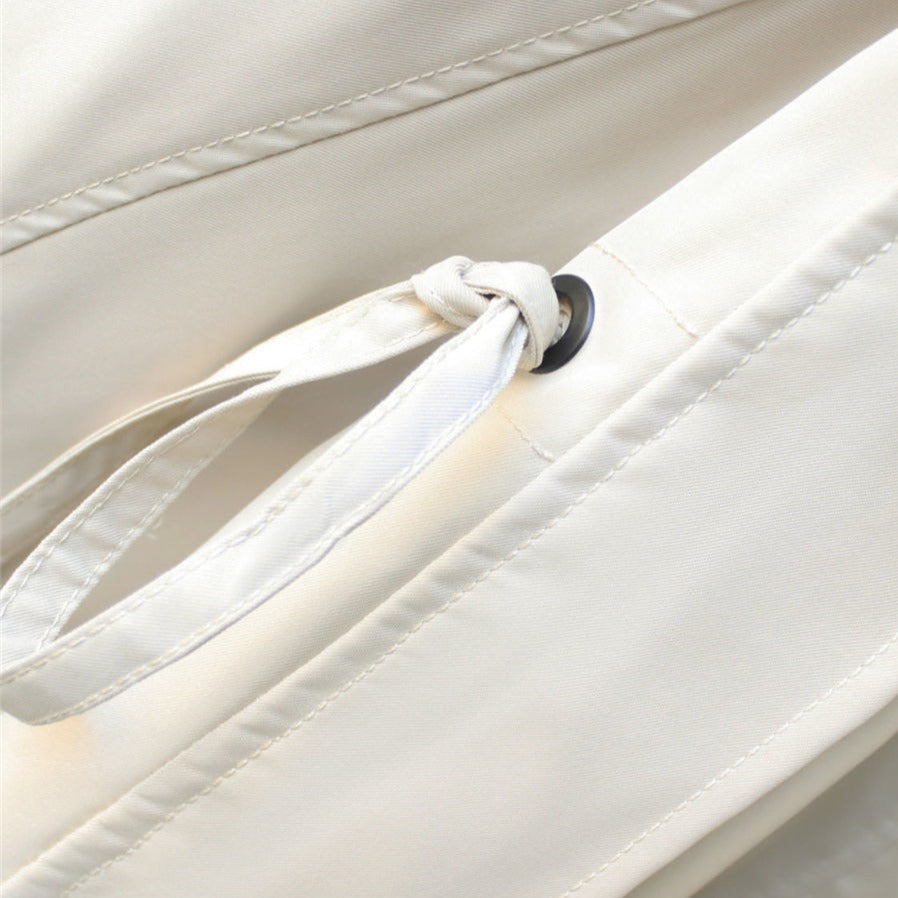 Detail of a women's waterproof rain jacket's hood. Stylish, lightweight design for all-weather fashion & protection.