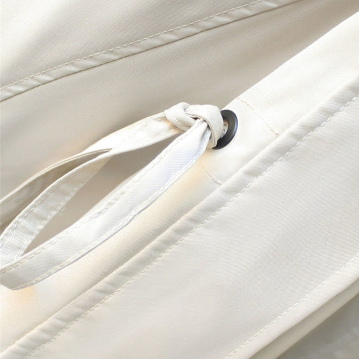Detail of a women's waterproof rain jacket's hood. Stylish, lightweight design for all-weather fashion & protection.