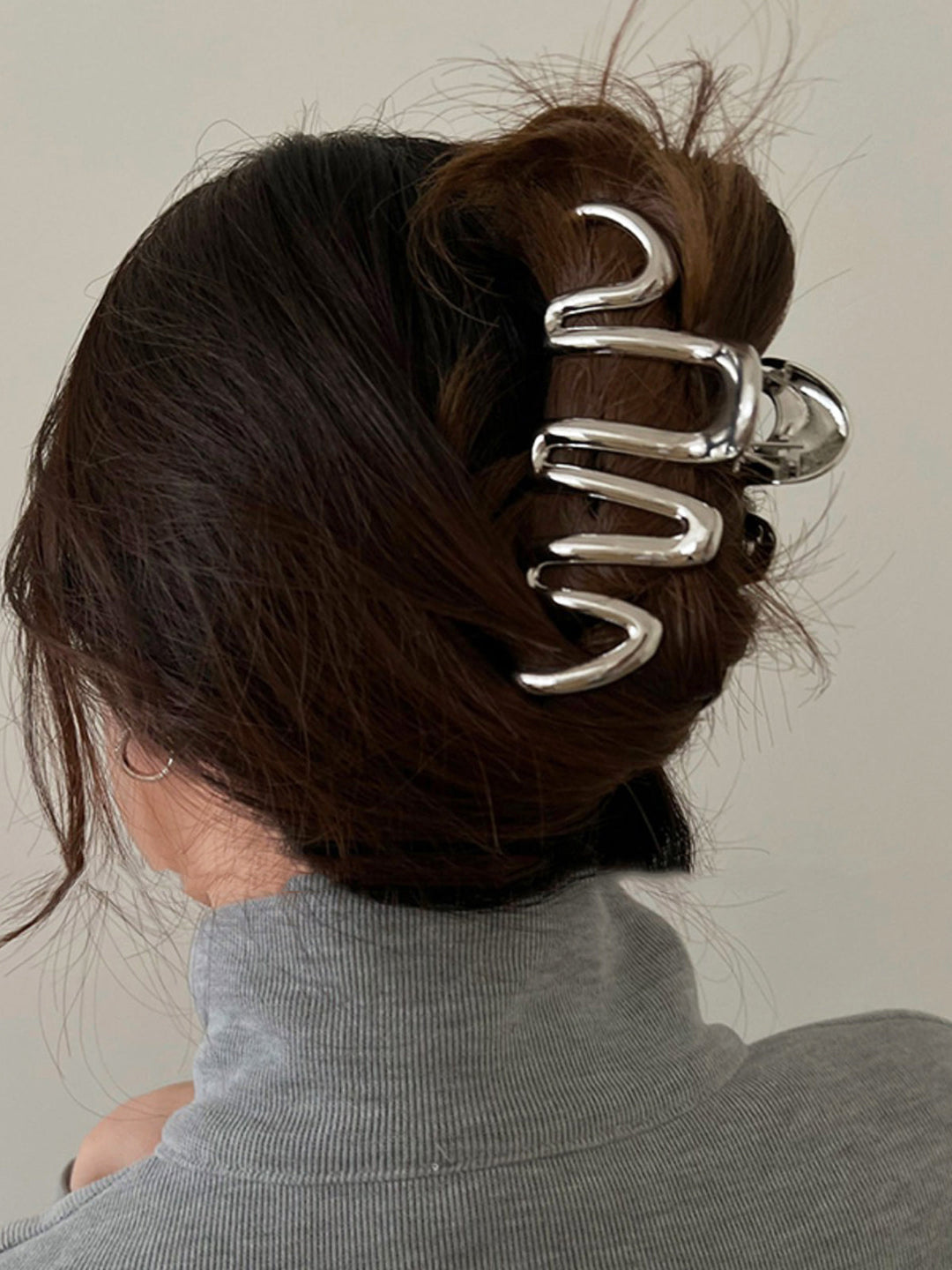 Stylish women's wave hair claw, perfect for securing elegant updos & everyday hair accessories.