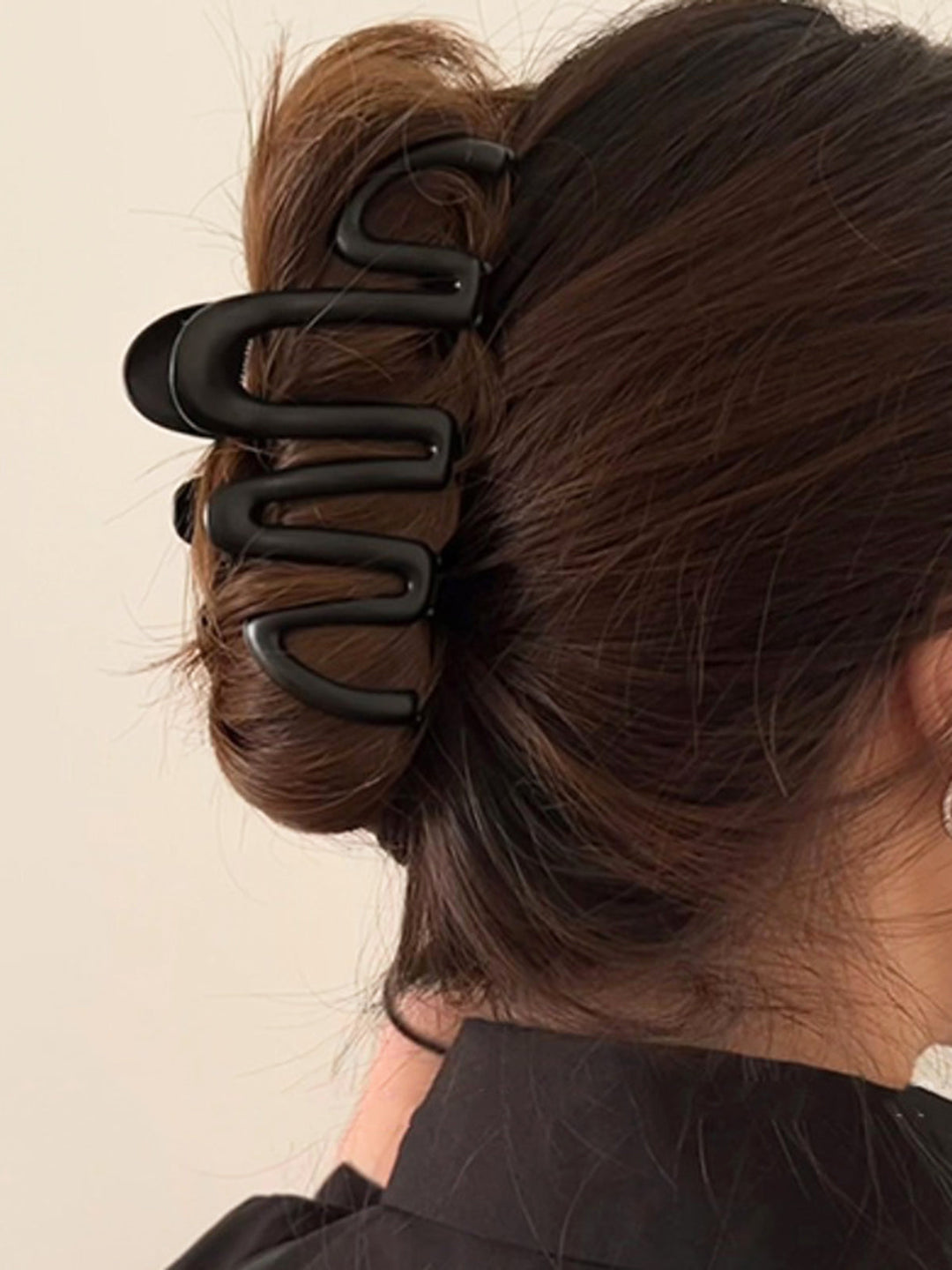 Modern metallic wave hair claw, a versatile women's hair accessory for elegant and secure updo styling.