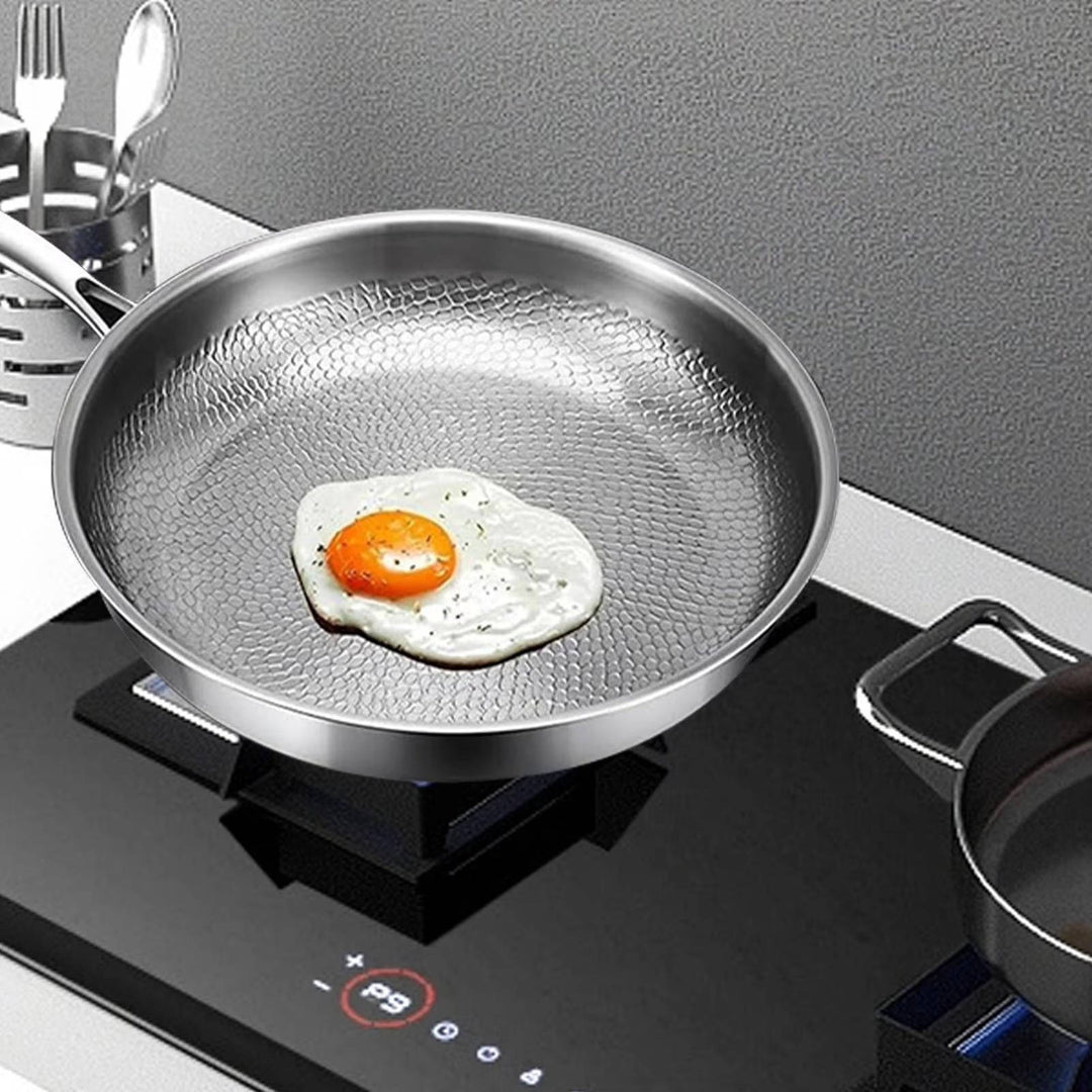 Deep titanium non-stick frying pan with unique fish scale texture. Versatile kitchenware for all cooking surfaces.