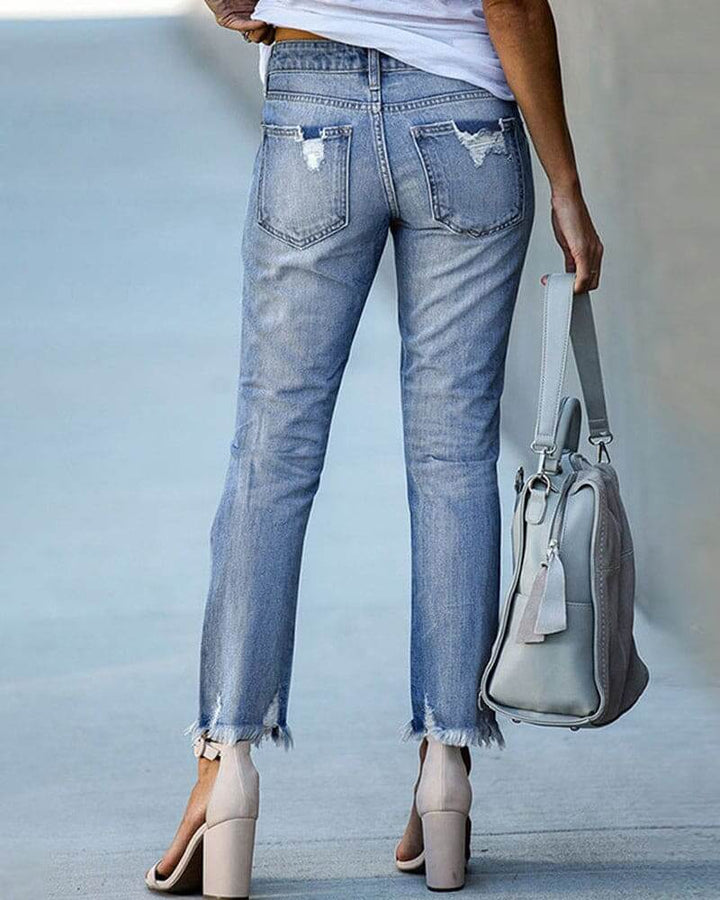 Stylish black ripped denim jeans for women, offering a trendy and edgy casual fashion statement.