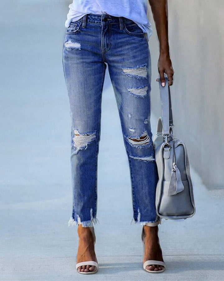 Light blue ripped denim pants for women, a trendy and comfortable choice for a modern casual outfit.