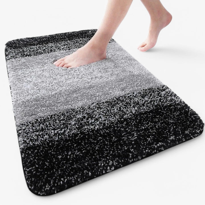 Absorbent non-slip bathroom mat. Microfiber comfort for dry feet & fall prevention. Washable bath rug.