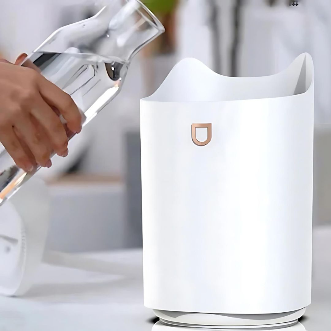 White ultrasonic humidifier generating fine mist for optimal air hydration, promoting wellness & better sleep.