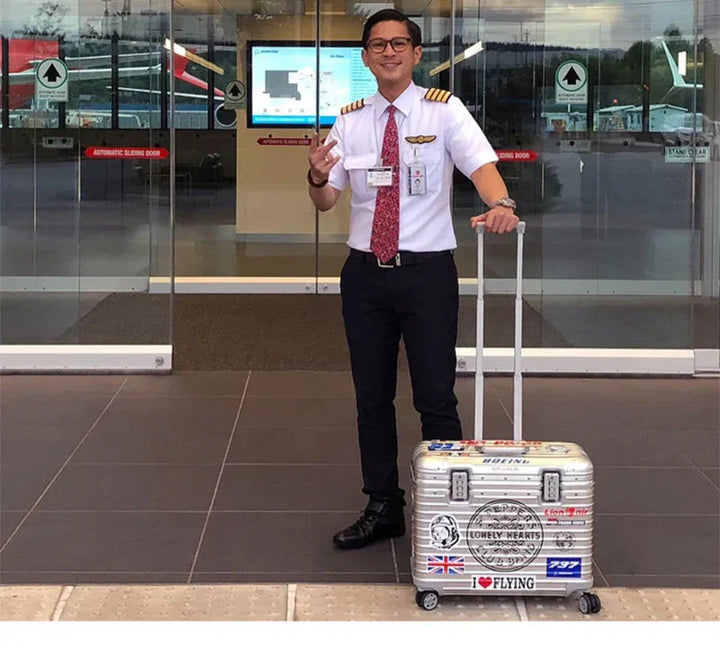 Modern unisex aluminum-magnesium spinner suitcase. Hard shell luggage with smooth wheels, ideal for effortless airport travel.
